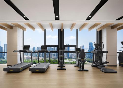 a gym with a view of a city skyline at Courtyard by Marriott Sejong in Sejong