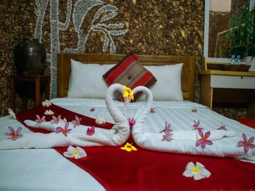 a bed with two swans made out of towels at Kep Villa Hill Guest House 1 in Kep