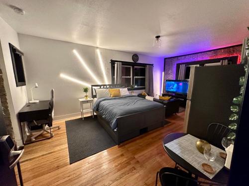 a bedroom with a bed and a desk and a piano at McKinley Beach Sunrise Studio - Pet Friendly in Milwaukee