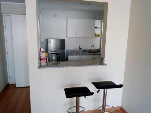a kitchen with two stools and a counter top at TUNA HOSTEL in Lima