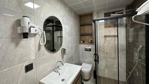 a bathroom with a sink and a shower at Quality Gold Suite Hotel in Antalya