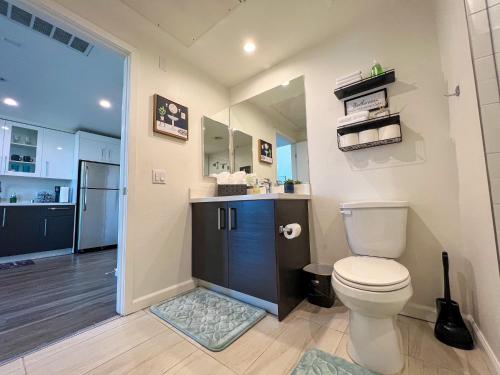 a bathroom with a toilet and a counter with a sink at Downtown Los Angeles Skyline balcony view Modern Penthouse in Los Angeles