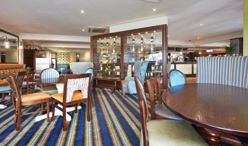 a restaurant with tables and chairs and a bar at The Wishing Well in Selby