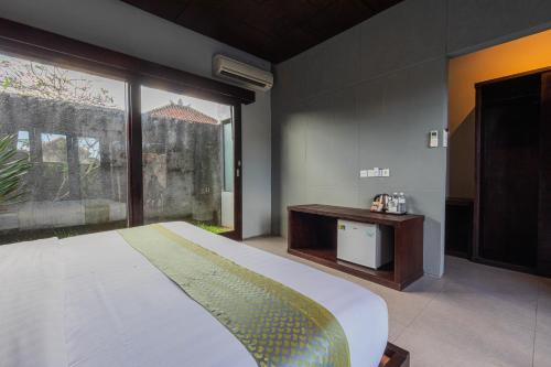 a bedroom with a bed and a large window at ME Villa Pererenan in Canggu