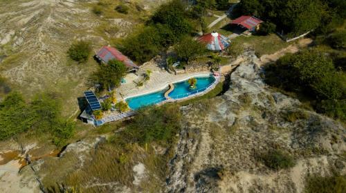 an aerial view of a swimming pool on a mountain at El Peñon De Constantino - Tatacoa in Villavieja