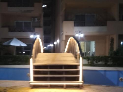 a wooden staircase in front of a building at night at شاليه ديمورا عائلات فقط Dimora Chalet Only Family in Dawwār Muḩammad Abū Shunaynah