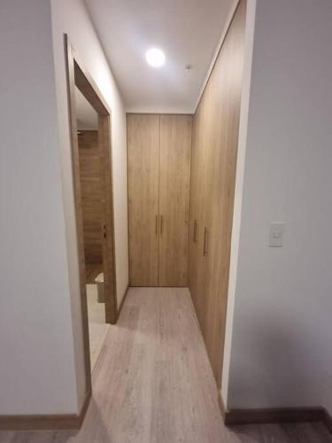 a hallway with wooden cabinets in a house at Suite Martina 2 Personas Quito in Quito