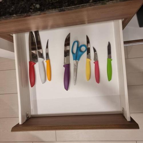 a group of knives hanging on a wall at Suite Martina 2 Personas Quito in Quito