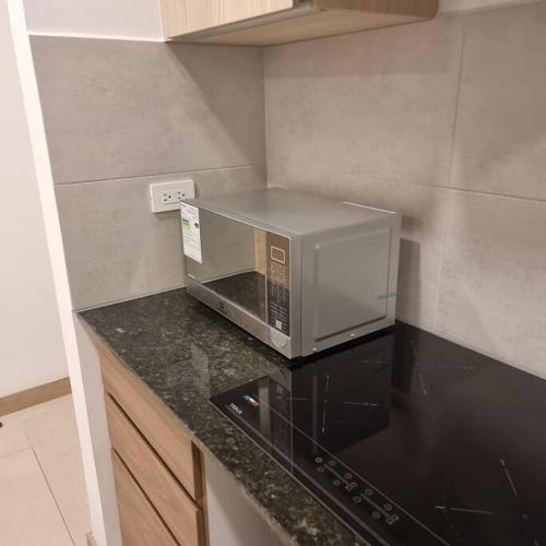a microwave sitting on top of a counter in a kitchen at Suite Martina 2 Personas Quito in Quito