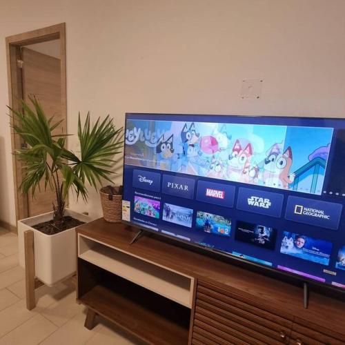 a large flat screen tv sitting on top of a table at Suite Martina 2 Personas Quito in Quito