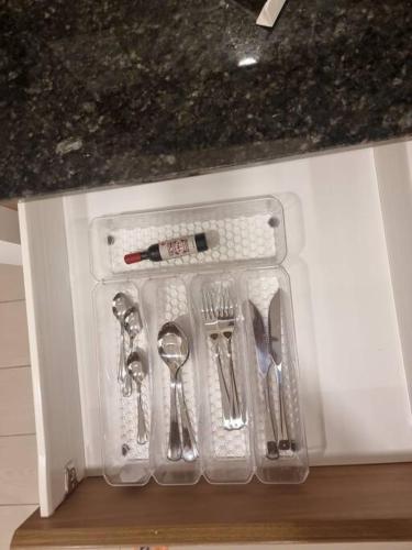 a plastic container with cutlery sitting on a counter at Suite Martina 2 Personas Quito in Quito