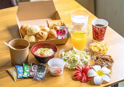 a table topped with a box of food and snacks at Hotel California Miyakojima Resort in Miyako Island