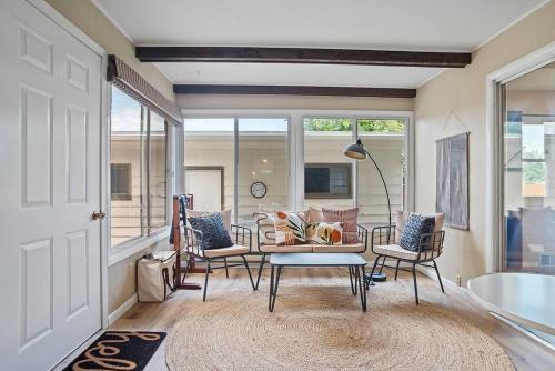 a living room with chairs and a table at Mid-Century Magic - HUGE Space in Rapid City