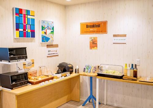 a fast food restaurant with a counter with food at Hotel California Miyakojima Resort in Miyako Island