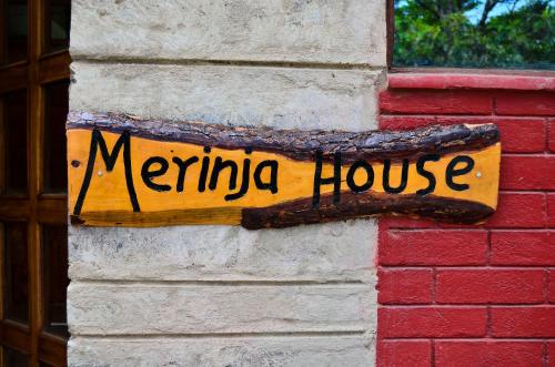 un panneau sur le côté d'un bâtiment dans l'établissement Merinja Guest House, à Naivasha