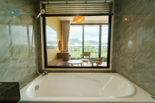 a bath tub with a view of a room at CAO BANG ECO HOUSE in Cao Bằng