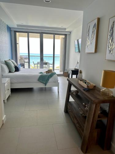 a bedroom with a bed and a view of the ocean at Azure 515 Aruba Vacation Sunset Breeze in Palm-Eagle Beach
