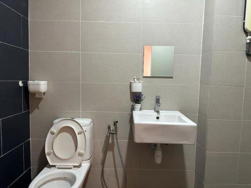 a bathroom with a toilet and a sink at 2 Storey, Hijayu 3D Alconix, Sendayan, Seremban in Seremban