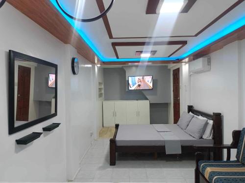 a room with a bed and a tv on a ceiling at Fabuluz Luxury at Princess Place in Malolos