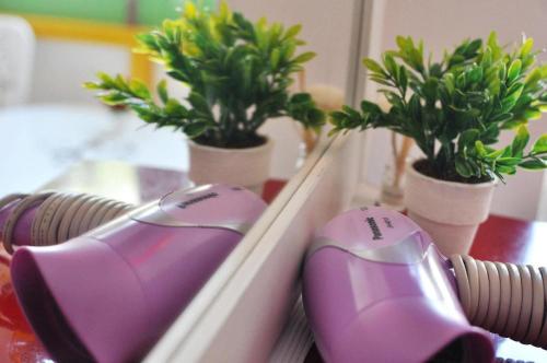 a purple computer mouse sitting next to potted plants at Sidewalk Boutique Hotel in Ko Samed