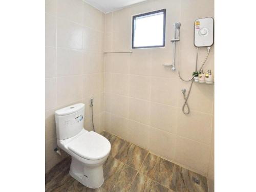 a bathroom with a toilet and a shower at Sidewalk Boutique Hotel in Ko Samed