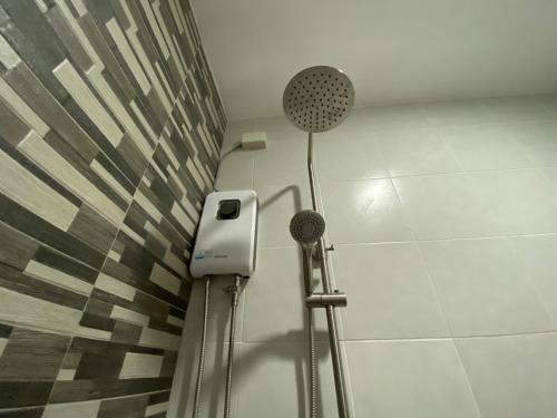 a shower in a bathroom with a shower at Max n Fe in Iriga City