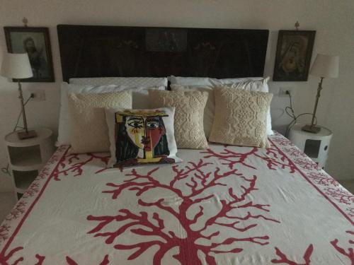 a bedroom with a bed with a tree on it at Antica Dimora La Corona in San Pantaleo