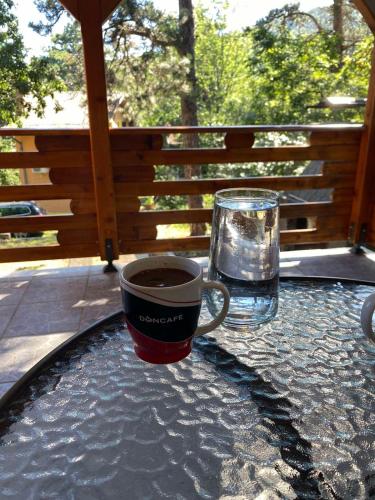 a cup of coffee and a glass of water on a table at Vila Vera in Vršac