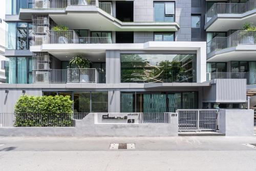 an apartment building with a lot of windows at Destiny63 Ekamai Apartment in Bangkok