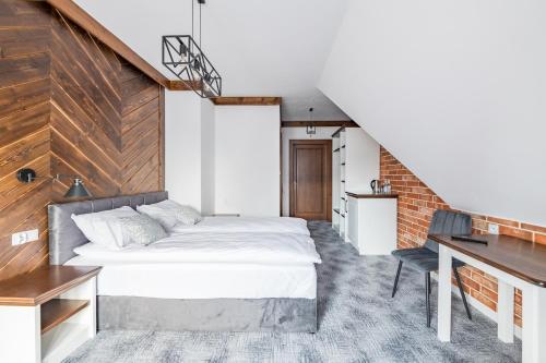 a bedroom with a bed and a desk at Willa Rzoz in Bukowina Tatrzańska