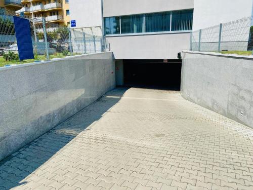 a tunnel in a building with a building at Hotel CONRAD Comfort in Kraków