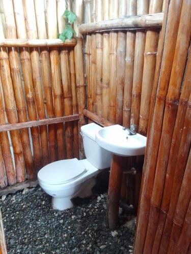 a bathroom with a toilet and a sink at WJV BEACH RESORT MOALBOAL in Cebu City