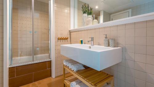 a bathroom with a white sink and a shower at Salobre Golf Villas Premium in Salobre