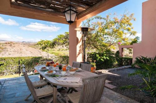 a wooden table and chairs on a patio at Salobre Villas in Salobre