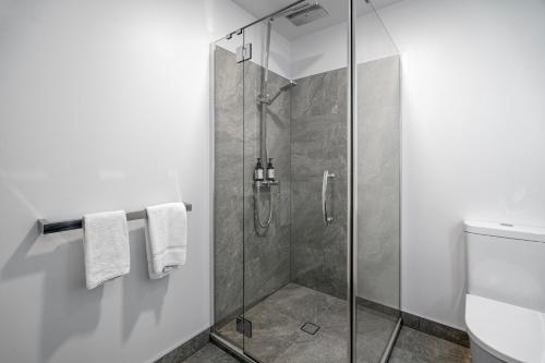 a shower with a glass door in a bathroom at Tasman Holiday Parks - Papamoa Beach in Papamoa
