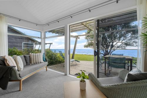 an open living room with a view of the ocean at Tasman Holiday Parks - Papamoa Beach in Papamoa