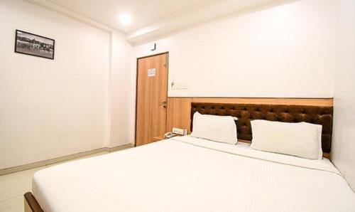 A bed or beds in a room at FabHotel Stay Inn International