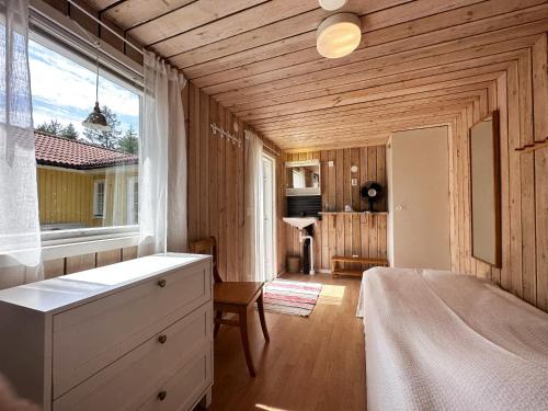 a bedroom with a bed and a large window at Cozy cottage on Gotland with sauna near salty baths in Lärbro