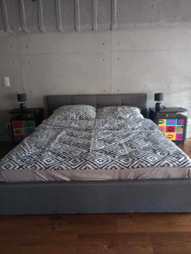 a bed in a room with a bed frame at RedCity LOFT 129 in Żyrardów