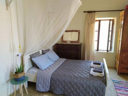 a bedroom with a bed with a canopy at Wonderful Summerhouse in Fánai