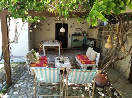 a patio with a table and chairs and a table and a couch at Wonderful Summerhouse in Fánai