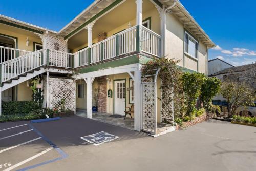a large house with a driveway in front of it at Carmel Inn & Suites in Carmel