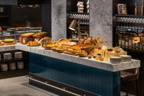 a buffet line with bread and other food items at InterContinental Kaohsiung by IHG in Kaohsiung