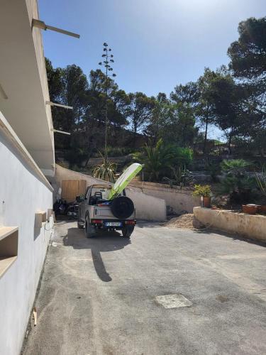 a truck parked in a driveway with a surfboard on the back at Villa Marna Bianca in Borgo Bonsignore