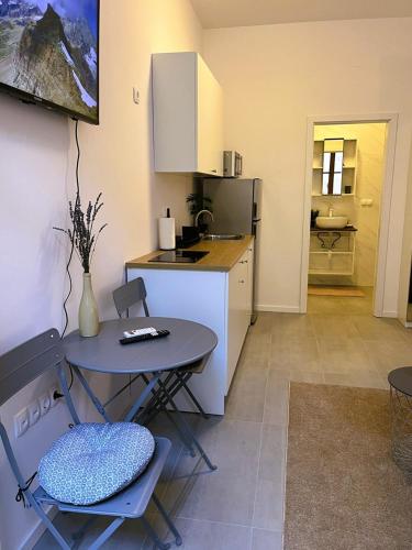 a kitchen with a table and a table and chairs at Zamaria Apartments in Vis