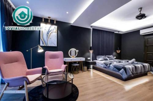 a bedroom with a bed and two pink chairs at JOVIAL PREMIUM DREAMHOUSE 4ROOM 8PAX@NEAR ICONCITY in Bukit Mertajam
