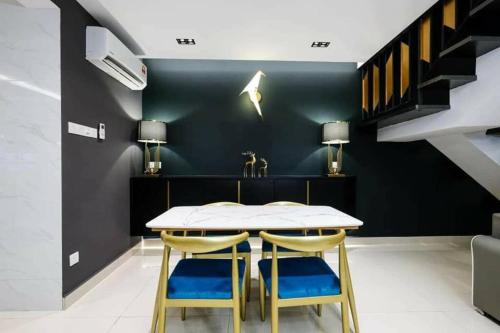 a dining room with a table and two chairs at JOVIAL PREMIUM DREAMHOUSE 4ROOM 8PAX@NEAR ICONCITY in Bukit Mertajam