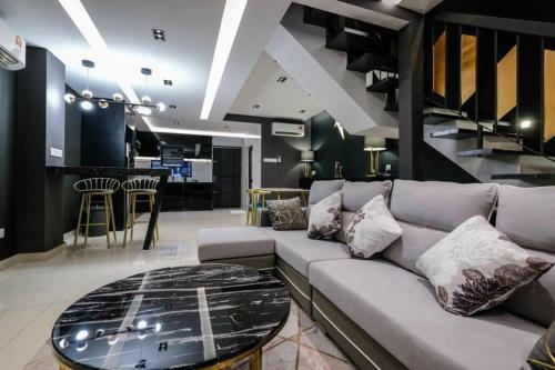 a living room with a couch and a glass table at JOVIAL PREMIUM DREAMHOUSE 4ROOM 8PAX@NEAR ICONCITY in Bukit Mertajam