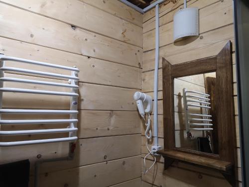 a bathroom with a mirror and a hair dryer at ДАН in Dragobrat