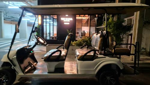 a golf cart parked in front of a building at The SACHA Apart-Hotel Thonglor in Bangkok